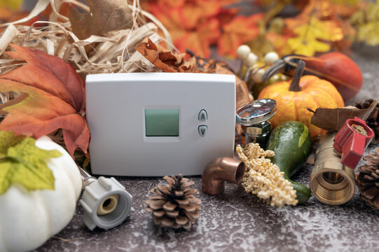 Construction tools and White thermostat  with maple leaves and pumpkin. contractor thanksgiving concept.   copy space. 