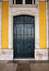 Large Old Wooden Door with Yellow Wall in Portugal Europe 