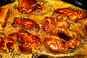 duck or goose foie gras cooking in a hot pan, oily and greasy delicacy food