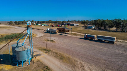Aerial view of trucks prepared to load corn grains after harvest in the field. Argentina