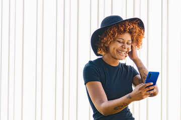afro american girl with mobile phone and hat