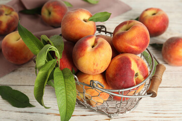Fresh ripe juicy peaches on white wooden table
