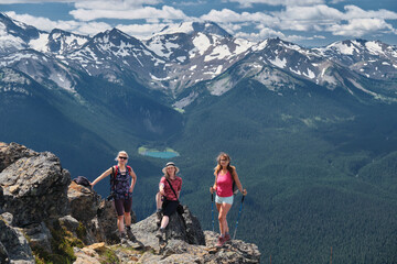 Group of people on cliff with glacier view. Whistler Blackcomb Ski resort in summer. British Columbia. Canada