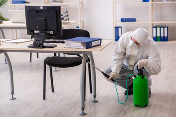 Old male contractor in office disinfection concept