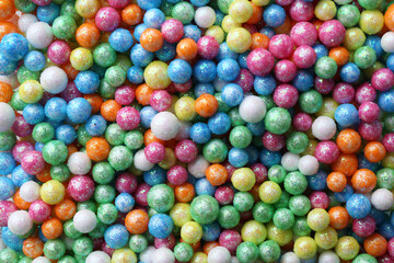 Fototapeta na wymiar Pile of small colorful beads as background, top view