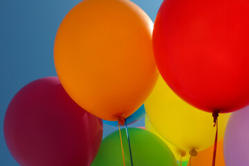 Bright colorful balloons with ribbons, closeup view