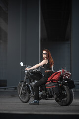 Plakat Girl biker sexually posing on motorcycle at night city