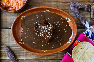 dish of mole poblano with piece of chicken and sesame, Mexico