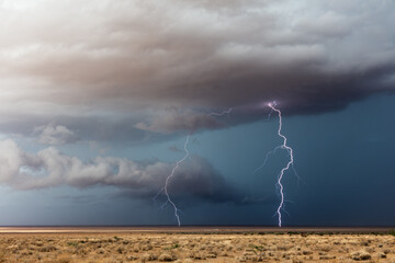 Lightning bolts strike ahead of a storm
