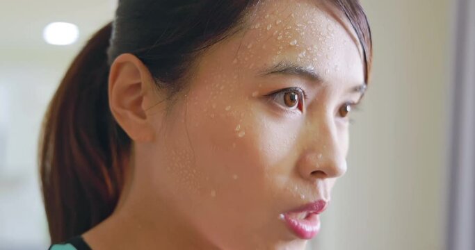 asian woman wipes sweat