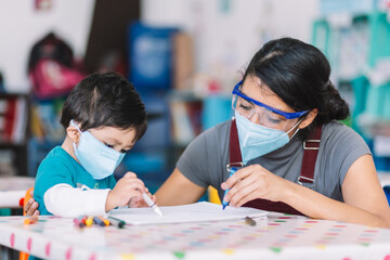 Mexican teacher and child with masks at school after covid-19 quarantine