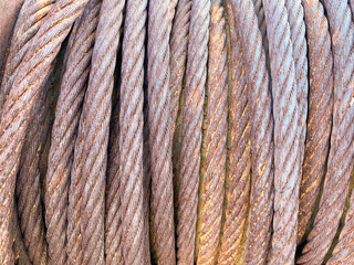 large roll of thick corroded rusted steel metal cable wire bundle