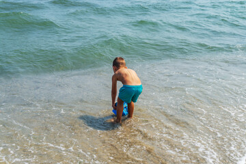kids building figures on the sand in a hot summer day, hands dig up the sand in a crisp plan