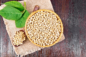 Soybeans in wicker bowl with leaf on board top