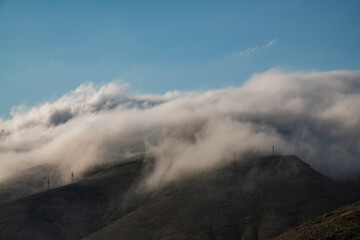 Beautiful mountains landscape, huge fluffy clouds descended to the mountain tops. Nature mountain wallpaper.