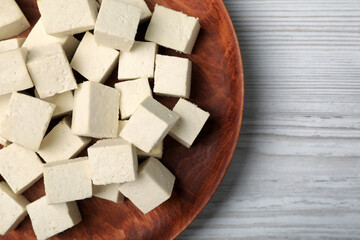 Delicious tofu on white wooden table, top view