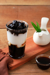 Es Cincau Hitam or Black Grass Jelly (Cincau Hitam), Indonesian Dessert Made from Cincau Leaf with Coconut Milk and Palm Sugar.