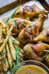 Roasted brined chicken drumsticks with herbs and french fries