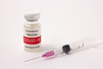 Glass bottle of Covid-19 vaccine and syringe isolated on a white background, red and white label, Healthcare and Medical concept. Injection device for preventing the spread of COVID-19 (Corona Virus).