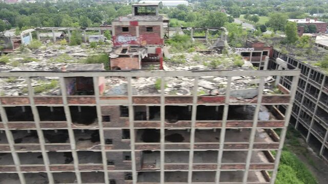 Abandoned Packard Automotive Plant in Detroit, Michigan drone video sweeping shot.