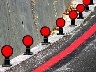 Road reflector beside a curved road,Traffic reflector,Road reflector 