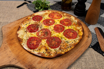 Neapolitan Brazilian pizza with mozzarella cheese and tomato slices with oregano