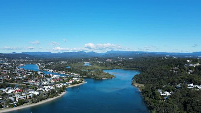 Scenic panorama of Tallebudgera Creek with the Gold Coast hinterland and cloud formation in the foreground. High drone view