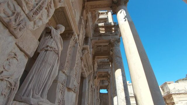 Upward panning, detail facade of the Celsus Library in Ephesus, with statue represents Sophia the wisdom. 
