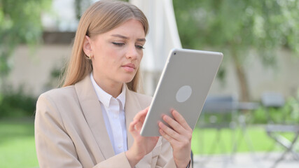 Outdoor Businesswoman Browsing internet on Tablet 
