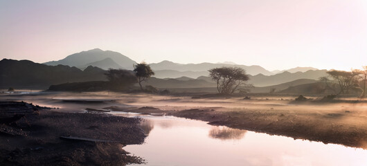Beautiful mountain and water lake view with fog of the UAE