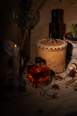Fantasy still life. Potion bottles, candle, medicine, broken amphora. Ingredients for making the potion.