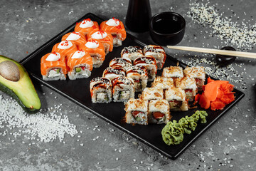 Sushi set with fresh ingredients on gray background. Sushi menu. Japanese food