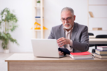 Aged male teacher in the classroom