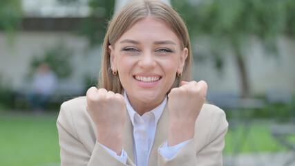 Outdoor Portrait of Businesswoman Celebrating Success 