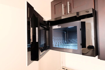 View inside of empty clean microwave oven, selective focus. Microwave interior with door opened. It...