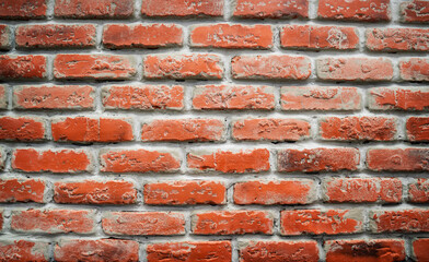 red brick wall.  The surface of a long thin bricks