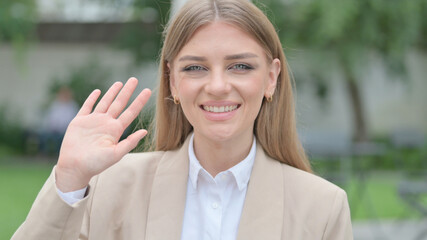 Outdoor Portrait of Businesswoman Waving at the Camera