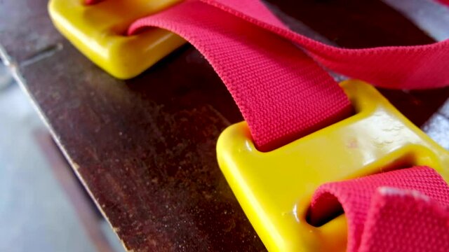 A bright red and yellow dive weight belt ready for scuba diving on a tropical island