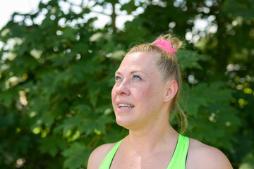 Attractive plump blond woman looking up at the sky