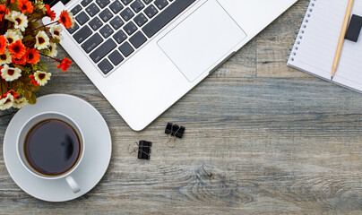 Obraz na płótnie Canvas Top view photo of laptop notebook computer and coffee cup on wooden background and copyspace. Business working space concept