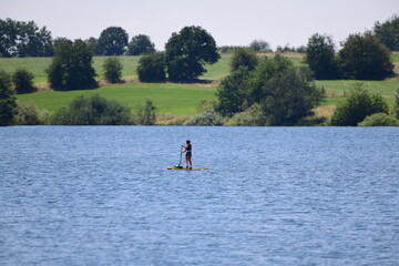 stand up paddler on a lake