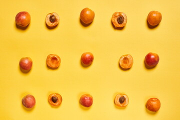 9 peaches arranged in order and divided by half on yellow background