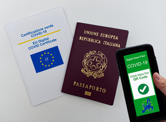 Digital green pass Covid-19 of EU on smartphone held by hand. Italian European Passport and EU digital Covid-19 Certificate. Safe travelling Concept