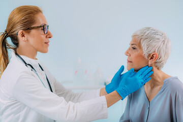 Doctor Examining a Senior Woman with Thyroid Gland Disease Symptoms