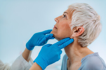 Endocrinologist Examining Senior Woman with Thyroid Gland Problems at a Clinic.