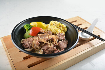 stir fried bbq bulgogi beef rice bowl with scrambled eggs and fried vegetable salad in black bowl in white marble healthy poke bowl menu