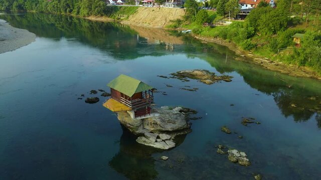 Aerial View, Small Fisherman House on Rock in Drina River, Bajina Basta, Serbia. Tourist Attraction and Sightseeing Location, Parallax Drone Shot