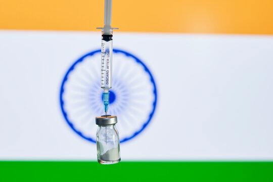 Wide spread of Indian strain of Covid-19 virus. Delta variant of new coronavirus. Vaccine ampule and syringe over Indian flag. Rolling out new vaccine against COVID-19 Indian strain or Delta variant - Powered by Adobe