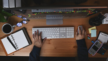 Businessman analyzing stock trading data on computer monitor.