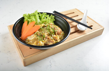 japanese oyakodon chicken rice bowl with salad in black bowl in white marble healthy poke bowl menu